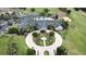 Aerial view of a resort-style clubhouse with pool, putting green, parking, and meticulously landscaped grounds at 2503 Squaw Crk, Clermont, FL 34711