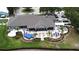 Aerial view of clubhouse with outdoor seating, bar, and landscaping at 2503 Squaw Crk, Clermont, FL 34711