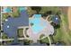 Aerial view of a community pool featuring ample seating, palm trees, and a covered gazebo at 2503 Squaw Crk, Clermont, FL 34711