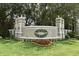 Welcoming community sign for Summit Greens, surrounded by lush landscaping and mature trees at 2503 Squaw Crk, Clermont, FL 34711