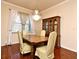 Charming dining room features an elegant chandelier, hardwood flooring, and a large wooden china cabinet at 2503 Squaw Crk, Clermont, FL 34711