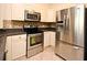 Modern kitchen with stainless steel appliances, tile backsplash, and bright cabinets at 2503 Squaw Crk, Clermont, FL 34711