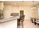 Modern kitchen with breakfast bar featuring stainless appliances and an adjacent dining area with a round table at 2503 Squaw Crk, Clermont, FL 34711