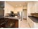 Well-equipped kitchen featuring stainless steel appliances, tile floors, and a breakfast bar with seating at 2503 Squaw Crk, Clermont, FL 34711