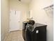 Functional laundry room with modern washer and dryer units, ample storage, and tiled flooring at 2503 Squaw Crk, Clermont, FL 34711