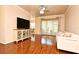 Bright living room with wood floors, a ceiling fan, and sliding glass doors to the outside at 2503 Squaw Crk, Clermont, FL 34711