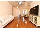 Open concept living room showcasing wood floors, a ceiling fan, and seamless access to the dining area at 2503 Squaw Crk, Clermont, FL 34711