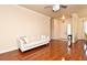 Inviting living room featuring a neutral sofa, hardwood floors, and direct access to the front door at 2503 Squaw Crk, Clermont, FL 34711
