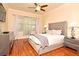 Comfortable main bedroom with hardwood floors, ceiling fan, and stylish gray furniture at 2503 Squaw Crk, Clermont, FL 34711