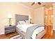 Cozy main bedroom with hardwood floors, ceiling fan, and stylish gray furniture at 2503 Squaw Crk, Clermont, FL 34711