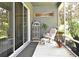 Cozy screened-in patio with comfortable seating and decorative plants, creating a relaxing outdoor space at 2503 Squaw Crk, Clermont, FL 34711