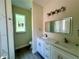 Bathroom featuring double vanity sinks, white cabinets, quartz counters, and modern fixtures at 335 Ruth Blvd, Longwood, FL 32750