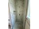 Beautifully tiled walk-in shower with a built-in niche and modern shower fixtures at 335 Ruth Blvd, Longwood, FL 32750