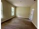 Cozy bedroom featuring wood-look flooring, neutral paint, and a bright window at 335 Ruth Blvd, Longwood, FL 32750