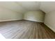 Spacious bonus room with laminate flooring and sloped ceilings at 335 Ruth Blvd, Longwood, FL 32750