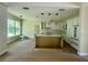 Bright kitchen with white cabinets, quartz countertops, stainless steel appliances and eat-in island at 335 Ruth Blvd, Longwood, FL 32750