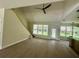 Bright living room featuring wood flooring, modern ceiling fan and multiple windows allowing natural light at 335 Ruth Blvd, Longwood, FL 32750