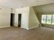 Inviting living room featuring a staircase, large windows, and neutral decor at 335 Ruth Blvd, Longwood, FL 32750