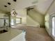 Bright, open-concept living space with wood-look flooring, modern light fixtures, and a staircase at 335 Ruth Blvd, Longwood, FL 32750