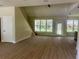 Bright, open living space with large windows, a staircase, and a rear patio door at 335 Ruth Blvd, Longwood, FL 32750