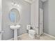 Half bath with pedestal sink, toilet, and blue walls at 3629 Vega Creek Dr, St Cloud, FL 34772