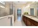 Bathroom featuring double vanity with granite countertops and glass enclosed shower at 3629 Vega Creek Dr, St Cloud, FL 34772