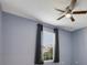 Cozy bedroom featuring a ceiling fan and a window with curtains at 3629 Vega Creek Dr, St Cloud, FL 34772