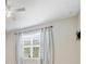 Bright bedroom window with white curtains offering natural light and a serene view of the outdoors at 3629 Vega Creek Dr, St Cloud, FL 34772