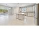 Bright kitchen with center island, stainless steel appliances and a sliding glass door to the exterior at 3629 Vega Creek Dr, St Cloud, FL 34772