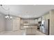 The bright kitchen features an island, stainless steel appliances, recessed lighting, and tiled floors at 3629 Vega Creek Dr, St Cloud, FL 34772