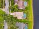 This aerial shows the proximity of backyard swimming pools to the neighborhood lake at 383 Brushwood Ln, Winter Springs, FL 32708