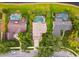 An aerial view shows multiple backyards with swimming pools in a verdant neighborhood at 383 Brushwood Ln, Winter Springs, FL 32708