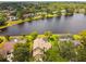 Aerial view of neighborhood with homes and screened in pools backing up to the lakefront at 383 Brushwood Ln, Winter Springs, FL 32708