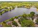 Beautiful aerial view of lakefront homes surrounded by lush greenery and mature trees in a peaceful neighborhood at 383 Brushwood Ln, Winter Springs, FL 32708