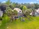 Large backyard with swimming pool, enclosed screened-in patio, and mature palm trees at 383 Brushwood Ln, Winter Springs, FL 32708