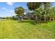 Sprawling backyard features mature palm trees, a large screened-in lanai, and a playset at 383 Brushwood Ln, Winter Springs, FL 32708