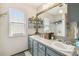 Bathroom featuring a double sink vanity, decorative shelving, and a rustic wood-trimmed mirror at 383 Brushwood Ln, Winter Springs, FL 32708