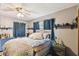 Bedroom with ceiling fan, and blue accents from the curtains and dresser at 383 Brushwood Ln, Winter Springs, FL 32708