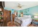 Charming bedroom with a white iron bed frame, wood accents, terra cotta tile and soothing turquoise walls at 383 Brushwood Ln, Winter Springs, FL 32708