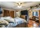 Bedroom featuring hardwood floors, a TV on a dresser and decor shelves at 383 Brushwood Ln, Winter Springs, FL 32708