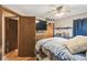Bedroom featuring neutral walls, wood floors, and access to another room through a wooden door at 383 Brushwood Ln, Winter Springs, FL 32708