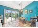 Dining room with a decorative chandelier and sliding doors leading to the screened-in porch at 383 Brushwood Ln, Winter Springs, FL 32708