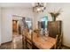 Dining room with wooden table, chandelier, and access to staircase and kitchen at 383 Brushwood Ln, Winter Springs, FL 32708