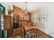 Dining room featuring a long wooden table, chandelier and shuttered window at 383 Brushwood Ln, Winter Springs, FL 32708