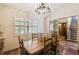 Dining room featuring a wooden table, chandelier, and a window with shutters at 383 Brushwood Ln, Winter Springs, FL 32708