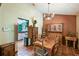 Dining room with rustic wooden furniture, chandelier, and access to kitchen at 383 Brushwood Ln, Winter Springs, FL 32708