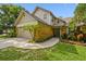 Charming two-story house with a two car garage, landscaped garden, and walkway at 383 Brushwood Ln, Winter Springs, FL 32708