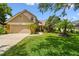 Charming two-story home featuring a well-maintained lawn, mature trees, and inviting curb appeal at 383 Brushwood Ln, Winter Springs, FL 32708