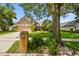 Charming two-story home with a manicured lawn, mature trees, and a brick mailbox at 383 Brushwood Ln, Winter Springs, FL 32708