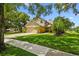 Well-maintained two-story home featuring lush green lawn and attached two car garage at 383 Brushwood Ln, Winter Springs, FL 32708